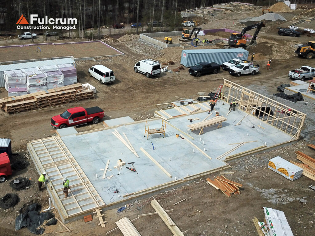 Concrete slab and early framing work at Brookline Woods workforce housing project in New Hampshire