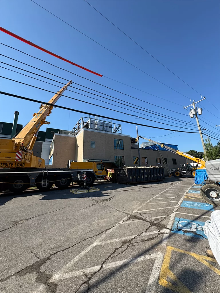 Construction crews and equipment supporting roof demolition at Southern New Hampshire Medical Center in Nashua, NH