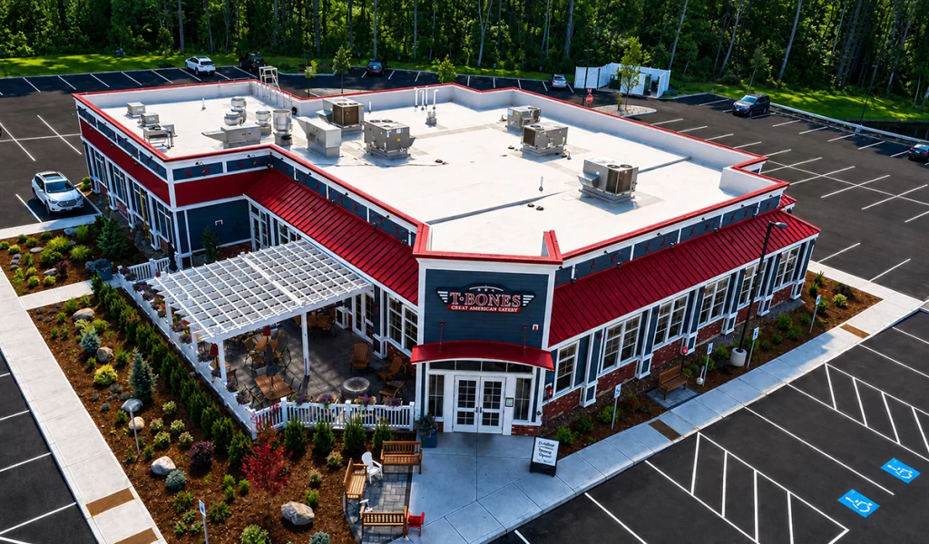 Aerial view of completed T-BONES Great American Eatery in Hudson NH showing outdoor dining area and parking facilities