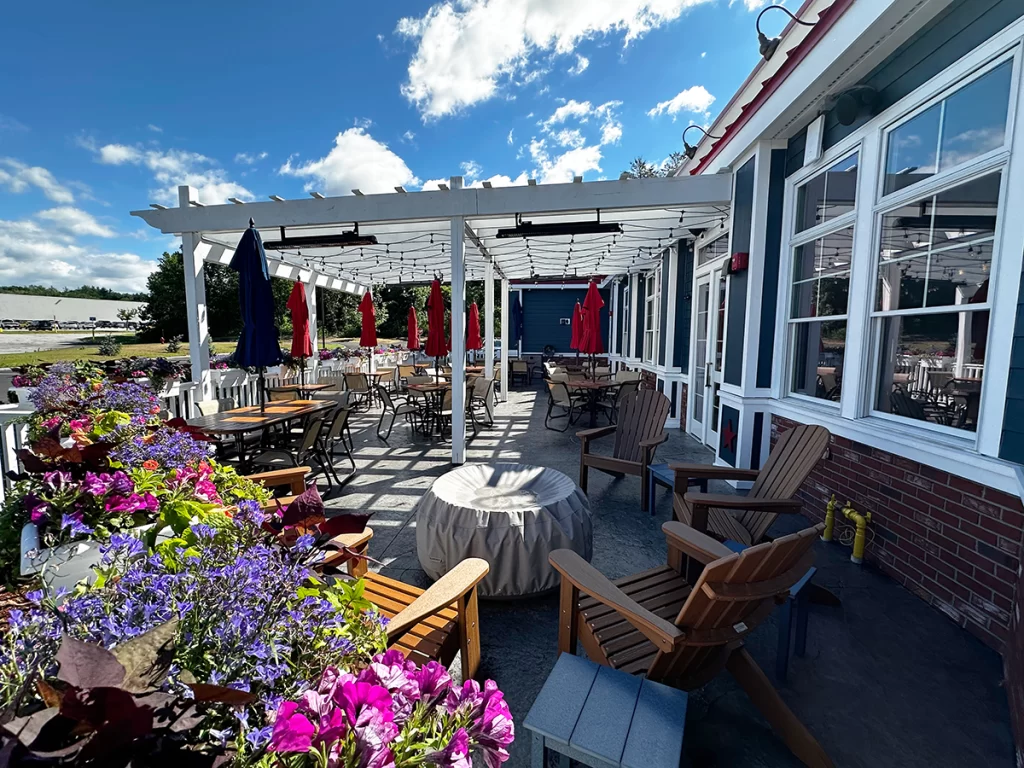 Outdoor dining patio with pergola seating at T-BONES Great American Eatery in Hudson NH